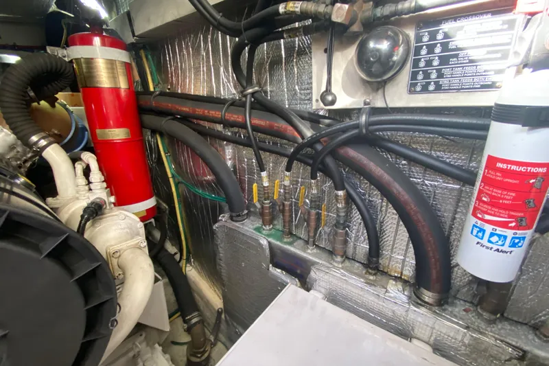  Yacht Photos Pics Engine room of 2006 Cruisers Yachts 520 Express with fire extinguisher and fuel lines.