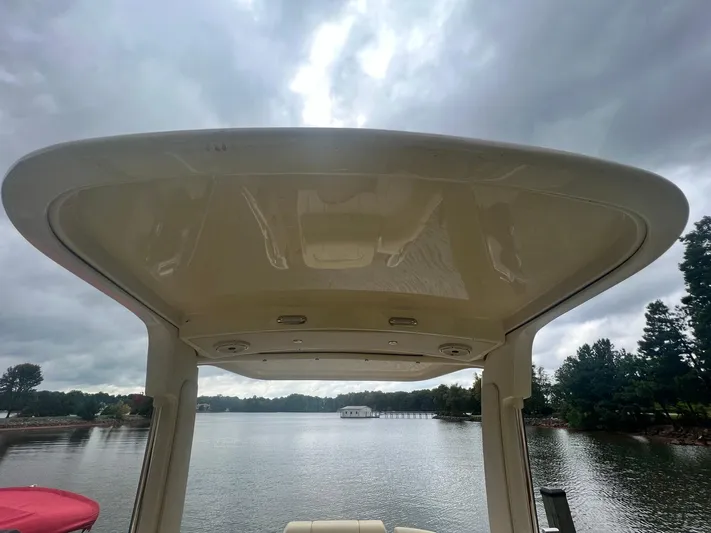  Yacht Photos Pics 2022 Chris-Craft Launch GT 28 Surf boat canopy on a cloudy day by the lake.