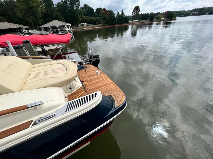  Yacht Photos Pics 2022 Chris-Craft Launch GT 28 Surf boat docked on a calm lake.