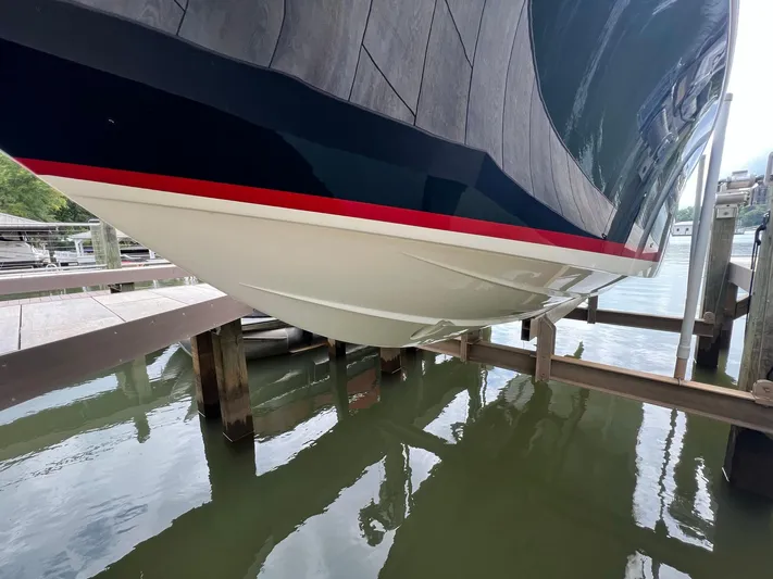  Yacht Photos Pics 2022 Chris-Craft Launch GT 28 Surf boat hull on lift at marina.