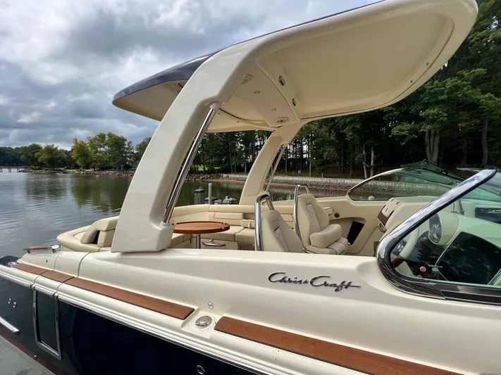  Yacht Photos Pics 2022 Chris-Craft Launch GT 28 Surf boat docked by a scenic lake.