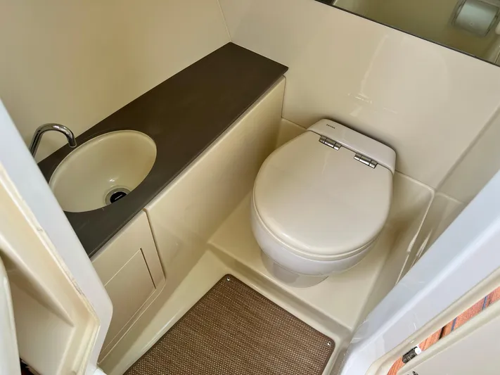  Yacht Photos Pics 2022 Chris-Craft Launch GT 28 Surf boat bathroom with sink and toilet.