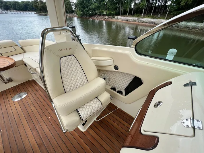  Yacht Photos Pics 2022 Chris-Craft Launch GT 28 Surf interior with luxurious seating and wooden deck.