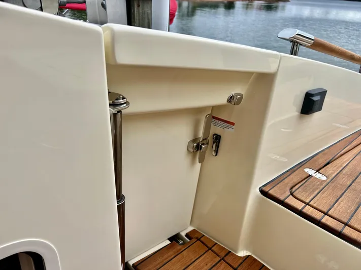  Yacht Photos Pics 2022 Chris-Craft Launch GT 28 Surf boat interior with teak flooring and stainless steel fixtures.