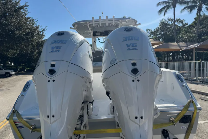  Yacht Photos Pics 2025 Sea Hunt Ultra 305 SE with dual Yamaha 300 V6 engines, parked outdoors.