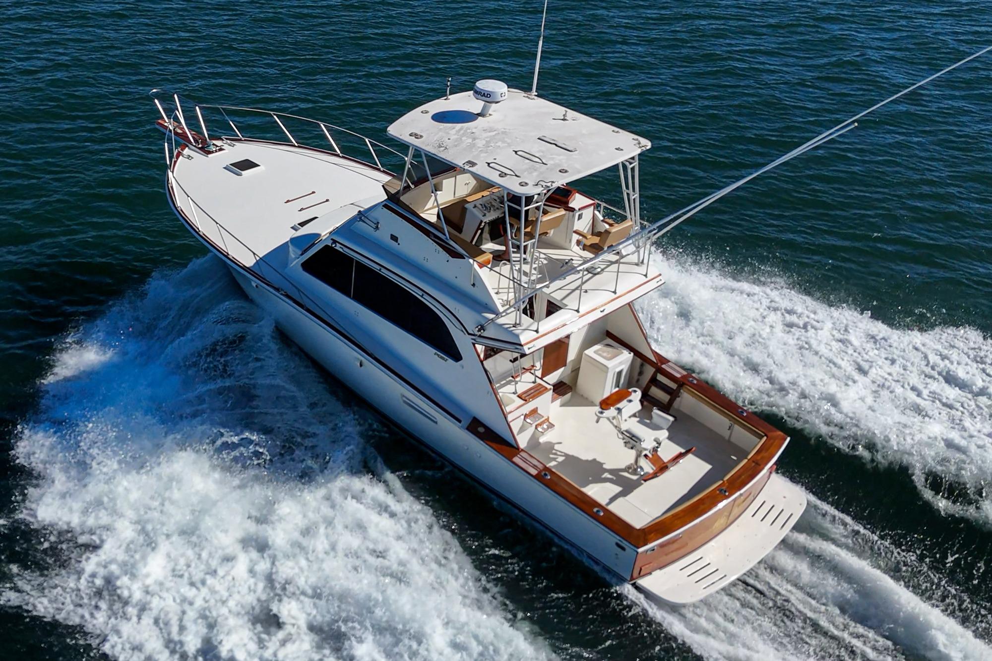 1984 Post 43 yacht cruising on open water, aerial view.