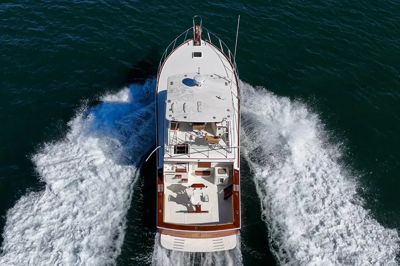 Un Dia Yacht Photos Pics Aerial view of 1984 Post 43 yacht cruising through ocean waters.