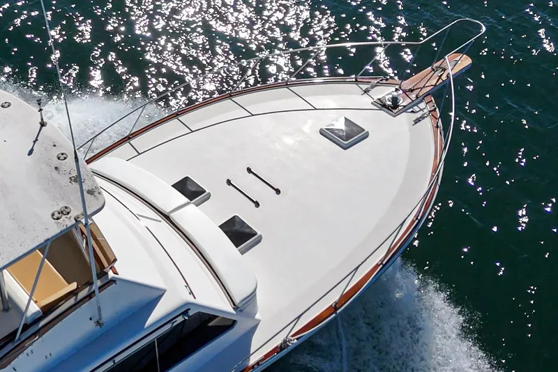 Un Dia Yacht Photos Pics Aerial view of 1984 Post 43 yacht cruising on sparkling water.