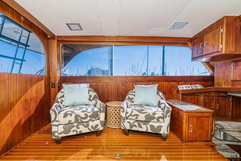 Un Dia Yacht Photos Pics Luxurious 1984 Post 43 yacht interior with elegant chairs and wooden cabinetry.