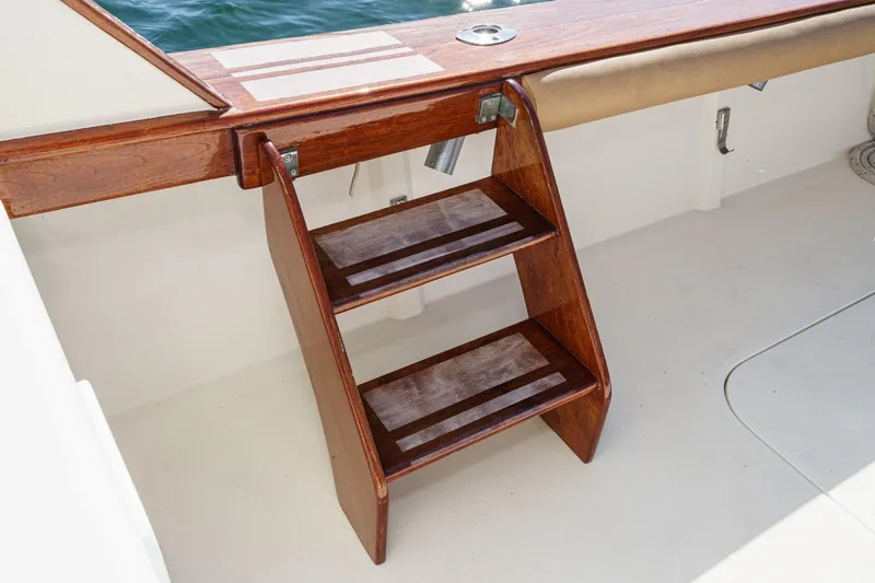 Un Dia Yacht Photos Pics Wooden boat steps on a 1984 Post 43 model, leading to the deck.