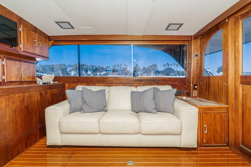 Un Dia Yacht Photos Pics Luxurious 1984 Post 43 yacht interior with white sofa and wooden accents.