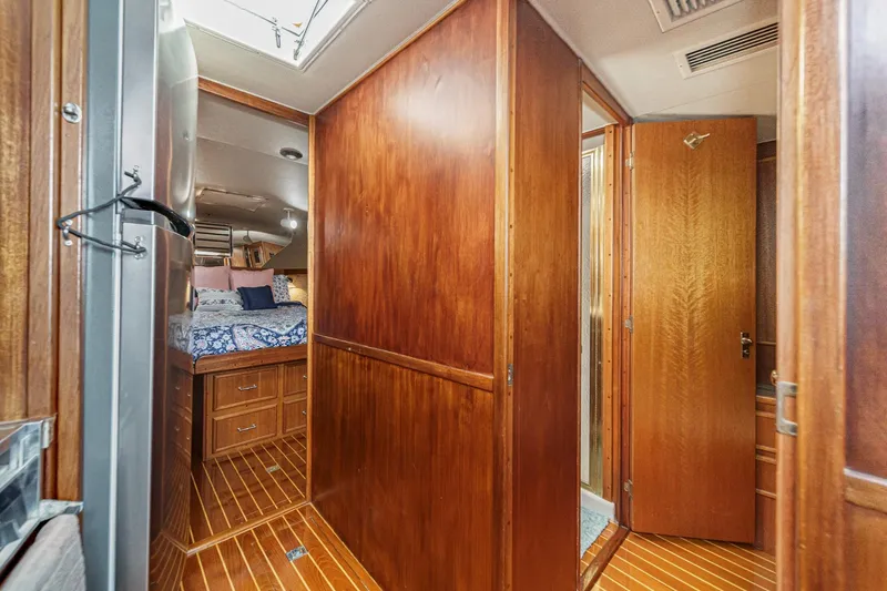 Un Dia Yacht Photos Pics Interior of 1984 Post 43 yacht with wooden paneling and cozy bedroom.