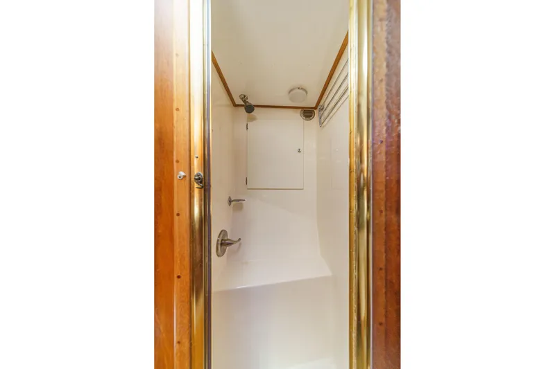 Un Dia Yacht Photos Pics Compact shower space with wooden trim in 1984 Post 43 model.