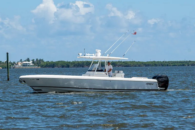  Yacht Photos Pics 2010 Intrepid 323 OPEN boat cruising on a sunny day with clear skies.