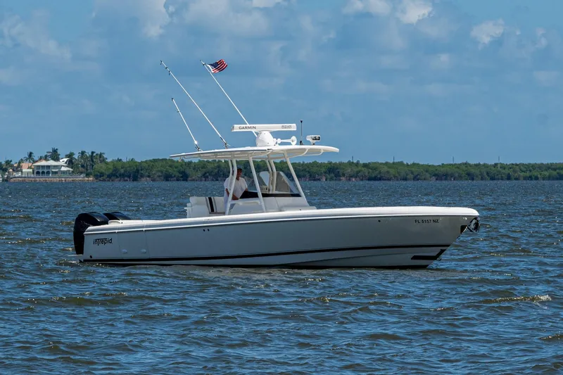  Yacht Photos Pics 2010 Intrepid 323 OPEN boat cruising on a sunny day with American flag.