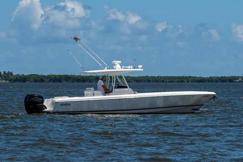  Yacht Photos Pics 2010 Intrepid 323 OPEN boat cruising on a sunny day with clear skies.