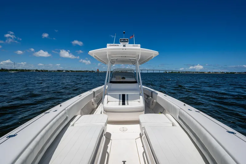  Yacht Photos Pics 2010 Intrepid 323 OPEN boat cruising on a sunny day with clear blue skies.