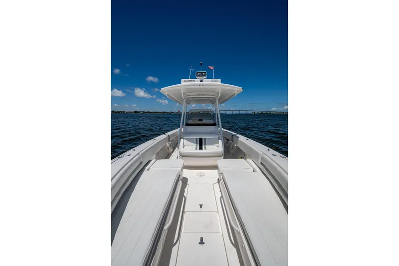  Yacht Photos Pics 2010 Intrepid 323 OPEN boat on calm water under clear blue sky.