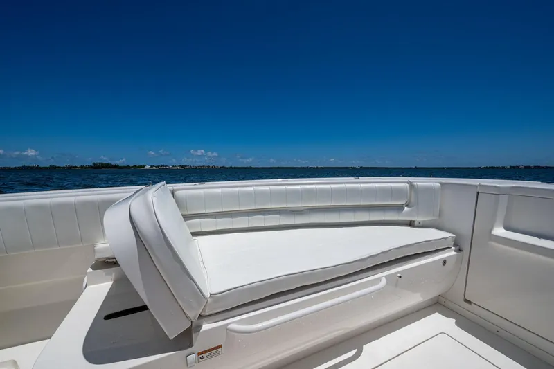  Yacht Photos Pics 2010 Intrepid 323 OPEN boat interior with white seating, ocean view, clear blue sky.