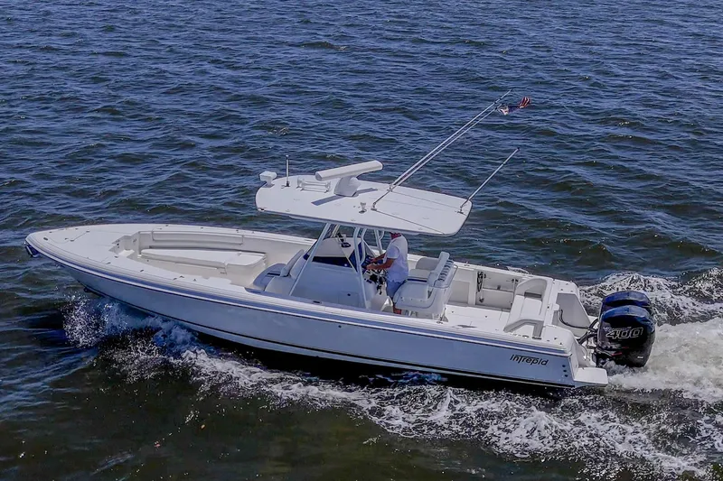  Yacht Photos Pics 2010 Intrepid 323 OPEN boat cruising on open water, side view.