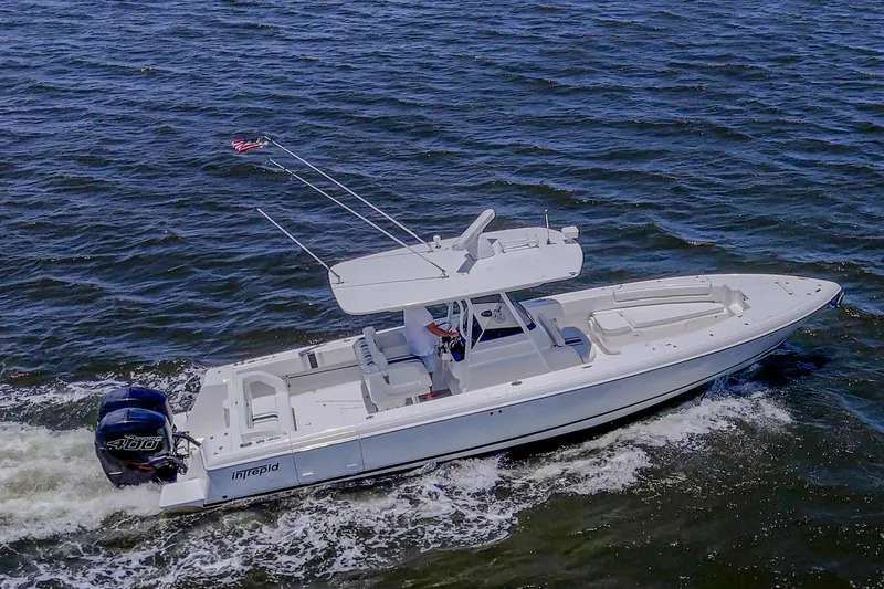  Yacht Photos Pics 2010 Intrepid 323 OPEN boat cruising on open water, featuring sleek design and powerful engines.