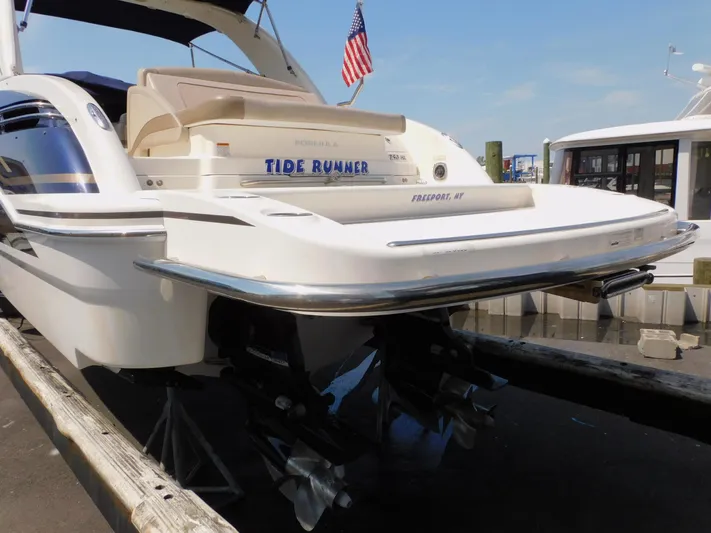 Tide Runner Yacht Photos Pics 2015 Formula Bowrider 290 boat docked, rear view with American flag.