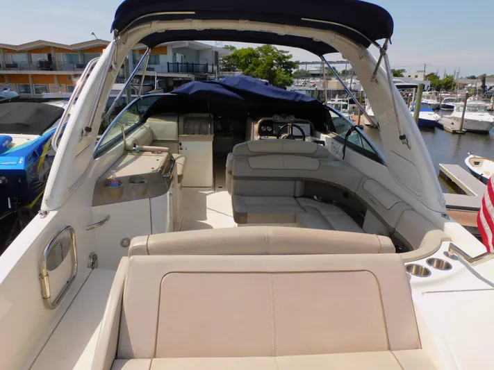 Tide Runner Yacht Photos Pics 2015 Formula Bowrider 290 interior with seating and helm, docked at marina.