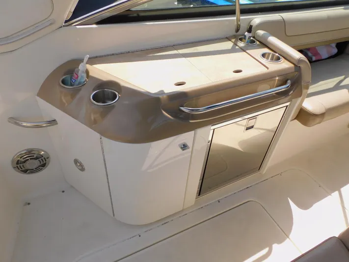 Tide Runner Yacht Photos Pics 2015 Formula Bowrider 290 interior with sink, cup holders, and storage cabinet.