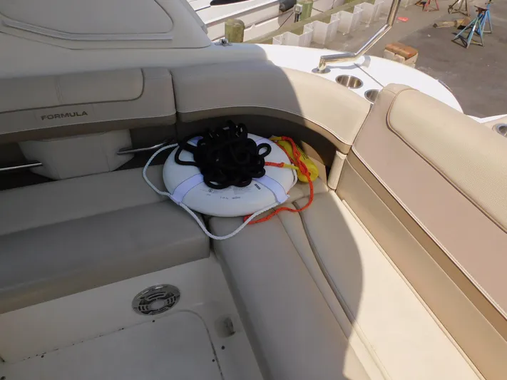 Tide Runner Yacht Photos Pics 2015 Formula Bowrider 290 interior with beige seating and life preserver.