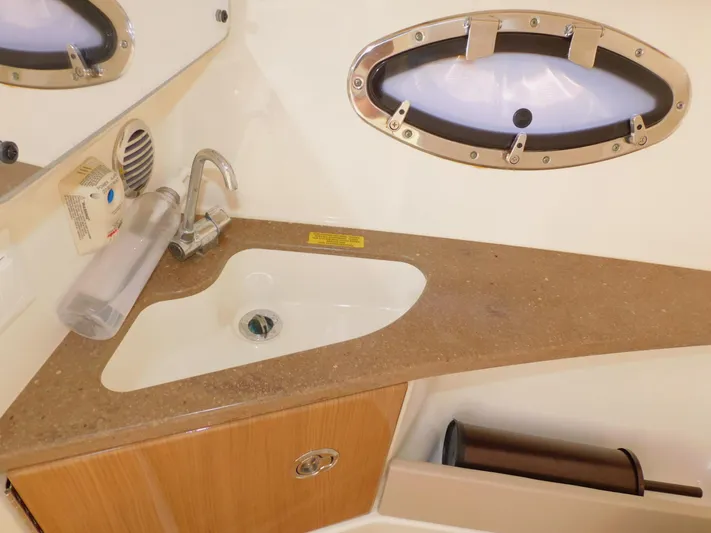 Tide Runner Yacht Photos Pics 2015 Formula Bowrider 290 bathroom sink with countertop and porthole window.