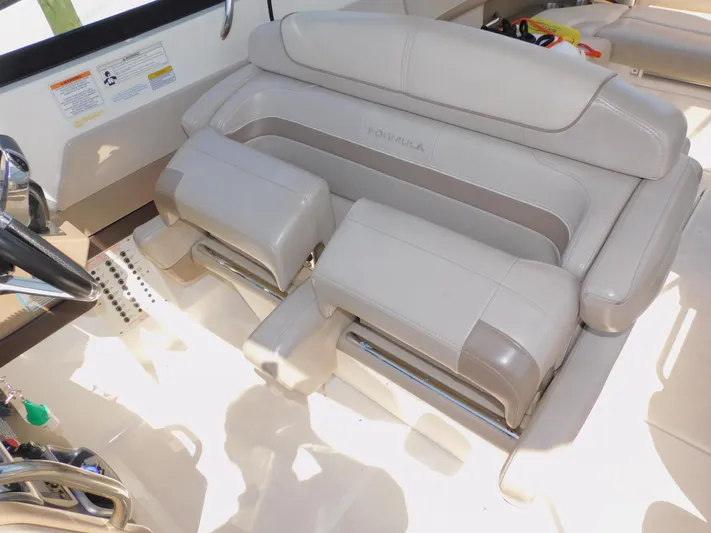 Tide Runner Yacht Photos Pics 2015 Formula Bowrider 290 interior with luxurious beige seating and steering wheel.