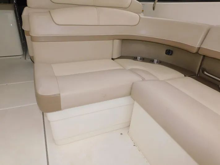 Tide Runner Yacht Photos Pics 2015 Formula Bowrider 290 interior seating with beige upholstery and cup holders.