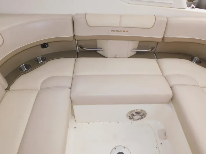Tide Runner Yacht Photos Pics 2015 Formula Bowrider 290 interior seating with beige upholstery and cup holders.
