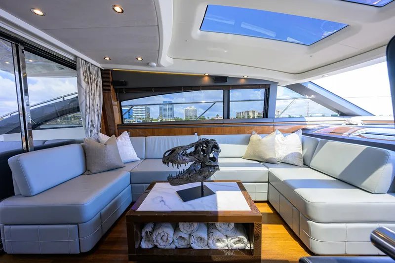 Alpha Dog Yacht Photos Pics Luxurious interior of 2015 Princess S62 yacht with modern seating and decorative centerpiece.