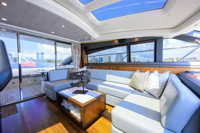 Alpha Dog Yacht Photos Pics Luxurious interior of 2015 Princess S62 yacht with modern seating and panoramic windows.