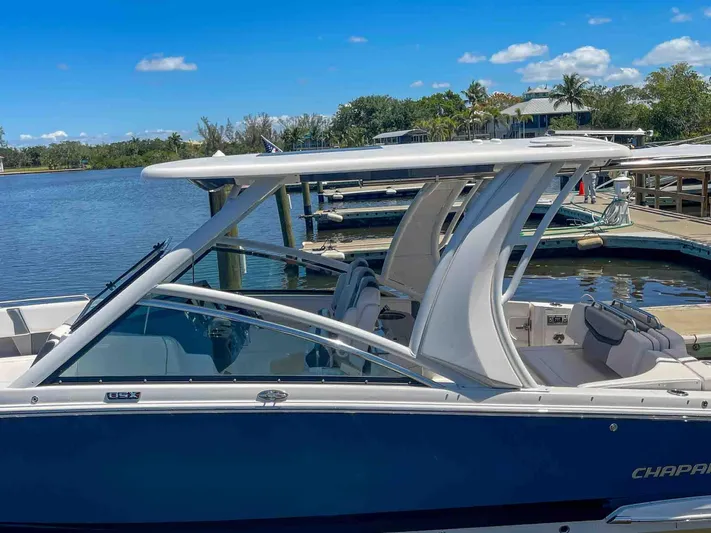  Yacht Photos Pics 2021 Chaparral 300 OSX boat docked by a scenic waterfront.