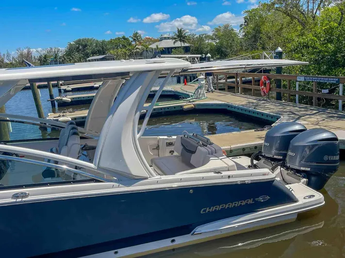  Yacht Photos Pics 2021 Chaparral 300 OSX boat docked, featuring dual Yamaha outboard engines, under a clear blue sky.