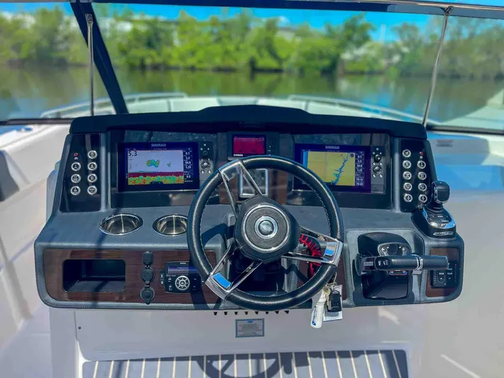  Yacht Photos Pics Helm of 2021 Chaparral 300 OSX boat with modern navigation displays and controls.