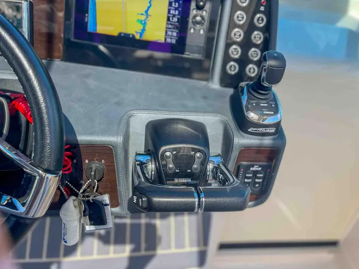  Yacht Photos Pics Control panel of 2021 Chaparral 300 OSX boat with steering and navigation equipment.