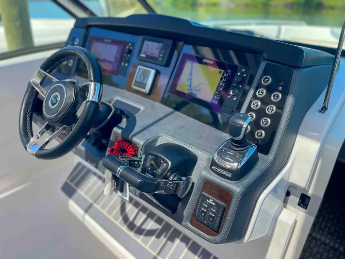  Yacht Photos Pics Helm of 2021 Chaparral 300 OSX boat with modern controls and navigation displays.