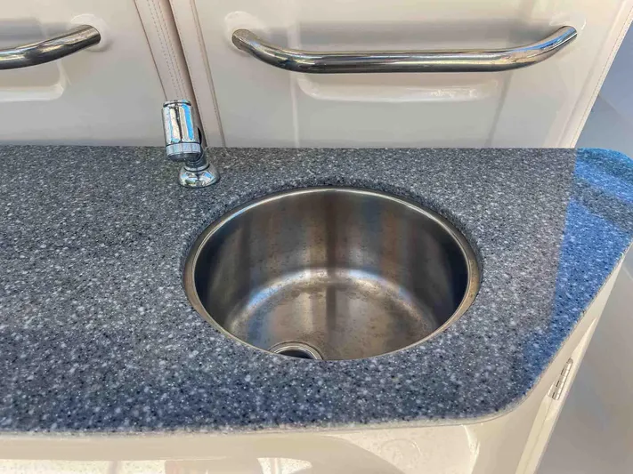  Yacht Photos Pics Stainless steel sink on 2021 Chaparral 300 OSX boat with granite countertop.