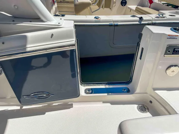  Yacht Photos Pics 2021 Chaparral 300 OSX boat interior with open storage compartment and sleek design.