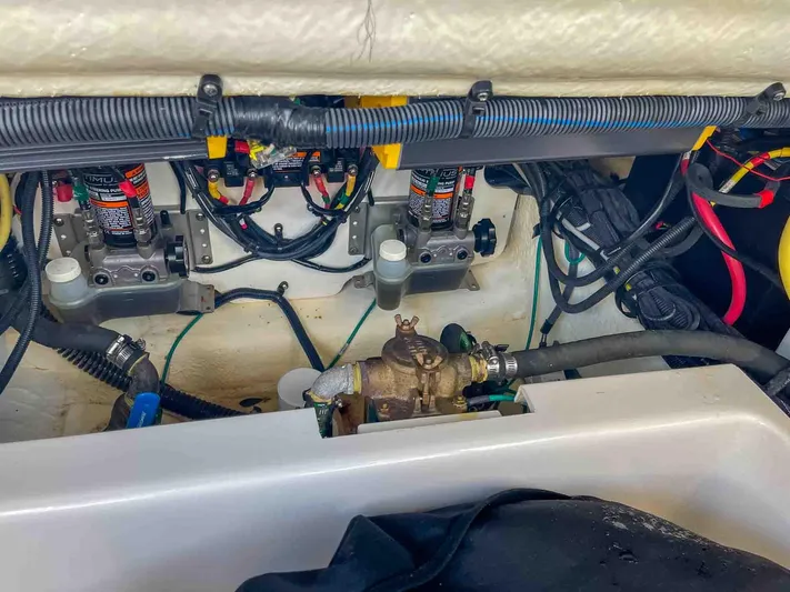  Yacht Photos Pics Engine compartment of a 2021 Chaparral 300 OSX boat, showcasing wiring and mechanical components.