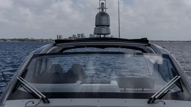  Yacht Photos Pics 2023 Azimut Atlantis 45 yacht on open water with city skyline in background.