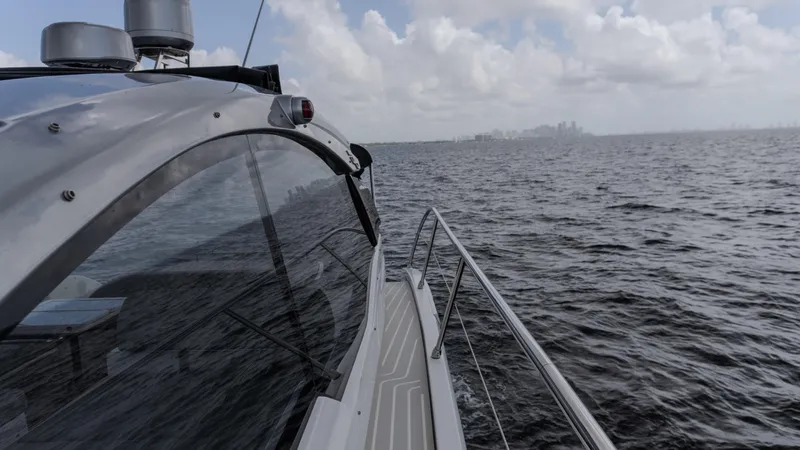  Yacht Photos Pics 2023 Azimut Atlantis 45 yacht cruising on open water under cloudy skies.