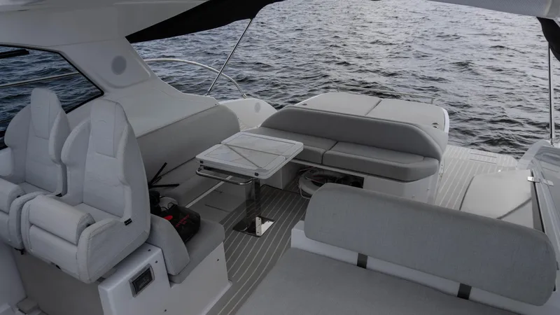  Yacht Photos Pics 2023 Azimut Atlantis 45 yacht interior with seating and table on open water.