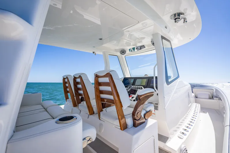  Yacht Photos Pics 2024 SeaVee 420Z boat interior with wooden seats, sleek design, and ocean view.