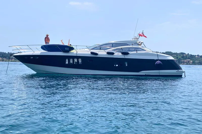  Yacht Photos Pics Luxury 2007 Absolute 56 HT yacht on serene blue waters, with scenic coastal backdrop.