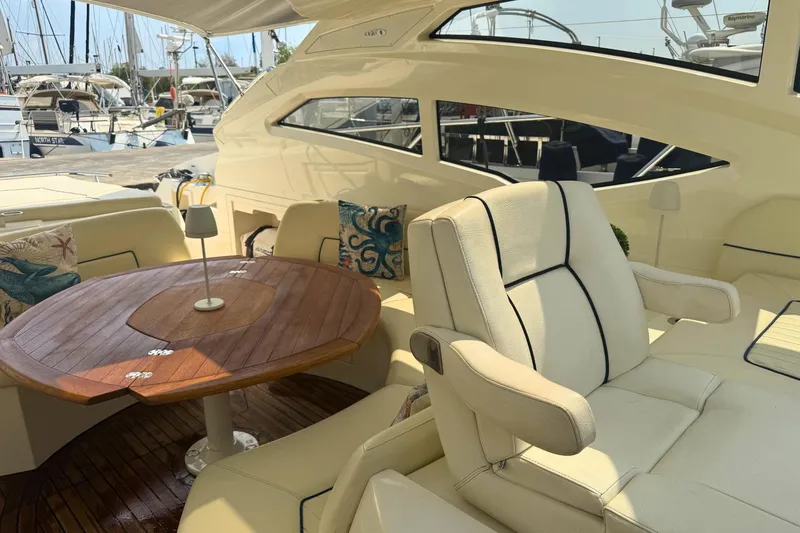  Yacht Photos Pics Luxurious 2007 Absolute 56 HT yacht interior with elegant seating and wooden table.