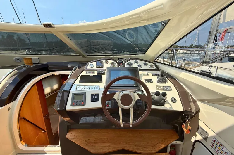  Yacht Photos Pics Cockpit of 2007 Absolute 56 HT yacht with steering wheel and navigation controls.